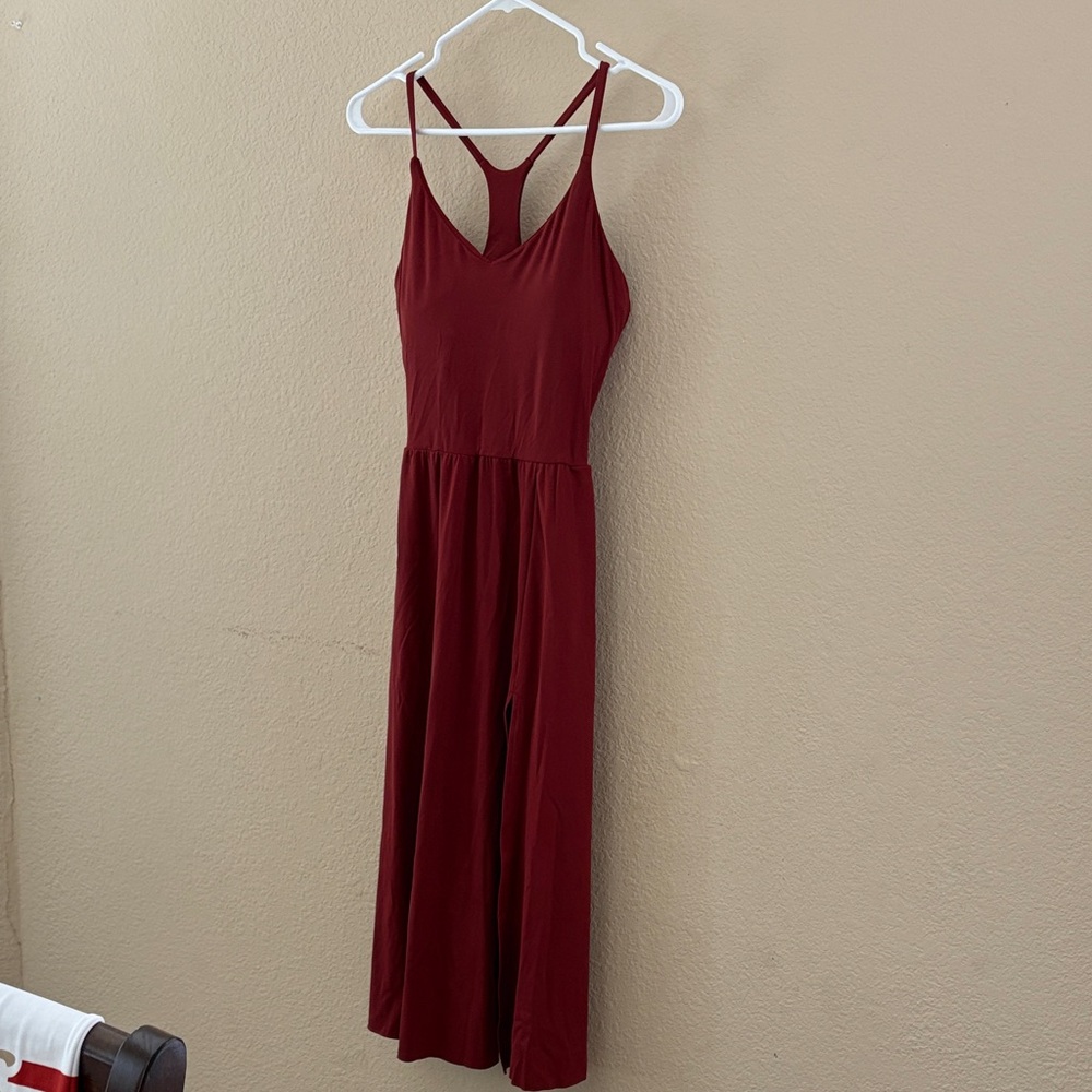 Red Sleeveless racerback dress with built in bra, left leg slit and pockets.